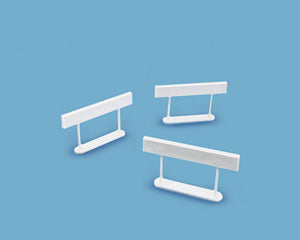 Three white model barricades on a blue background