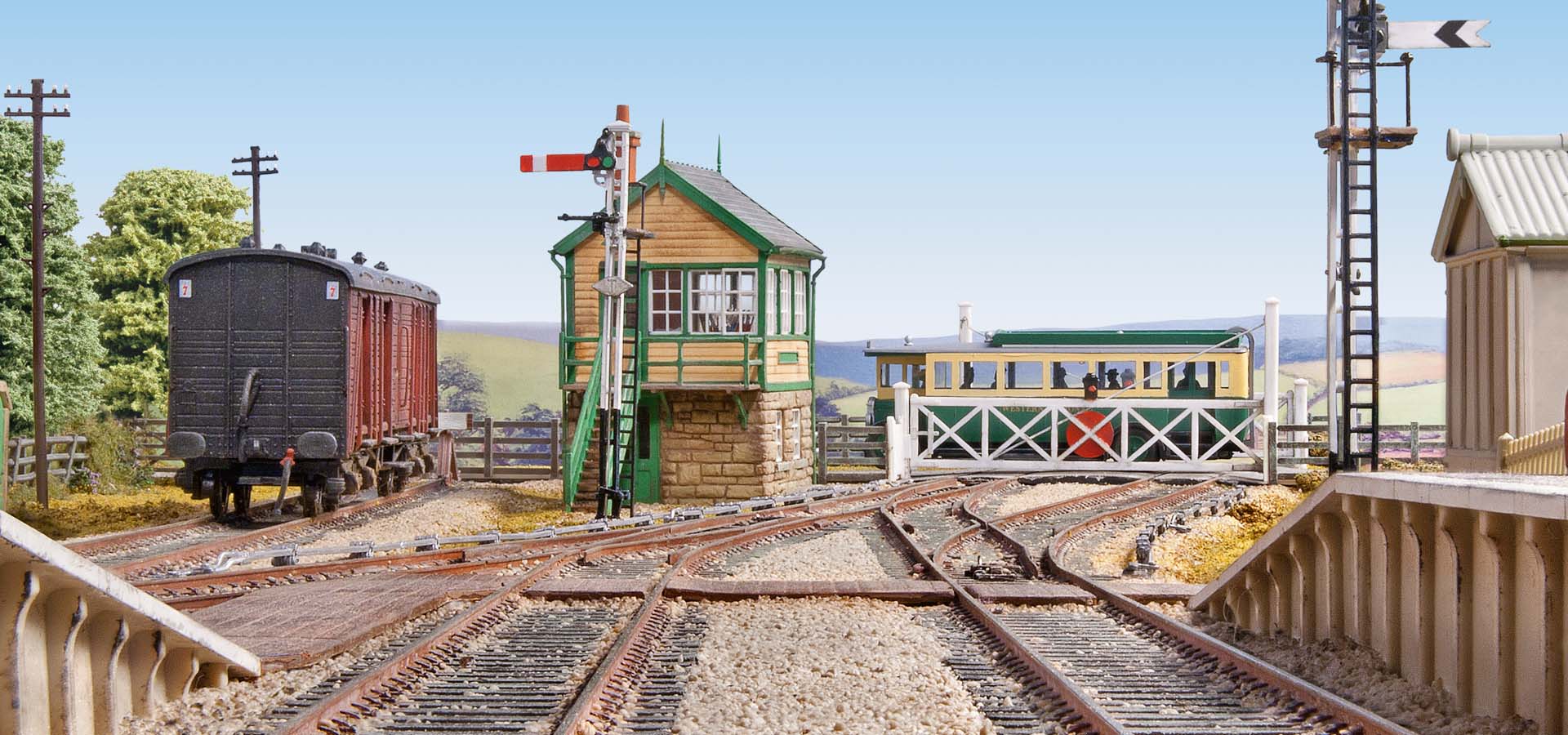 Model train set on tracks with buildings and trees in the background